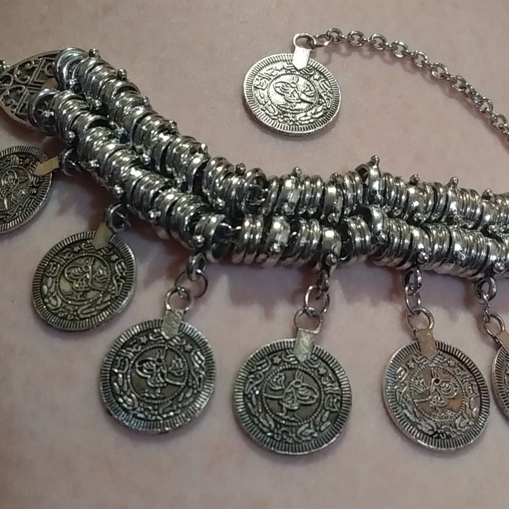 Silver dangle bracelet with coins from across seas